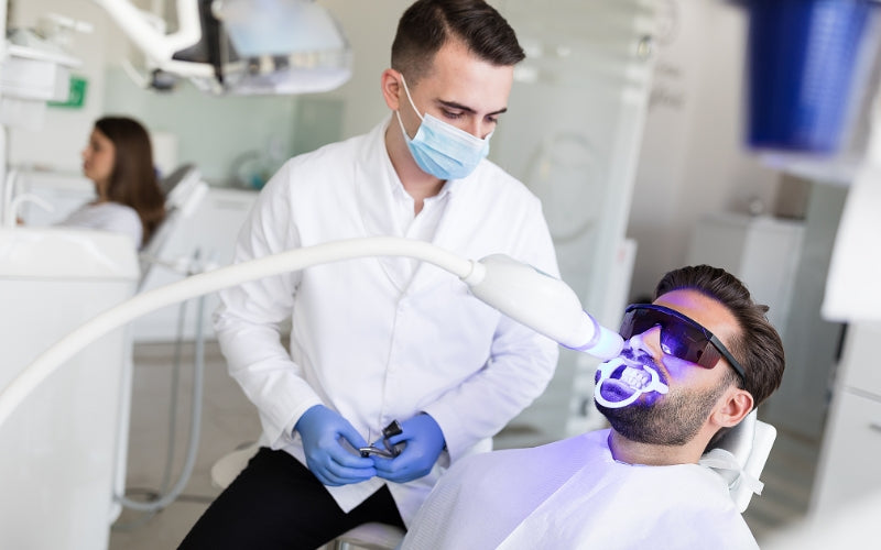 A person receiving teeth whitening treatment