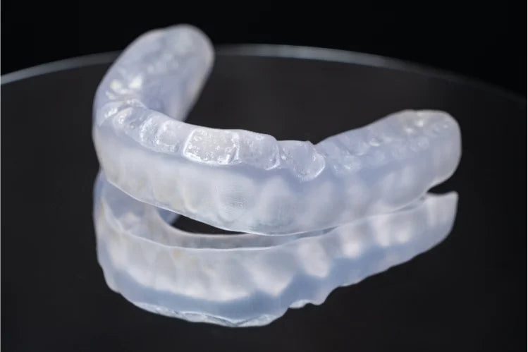 A dental Night Guard placed on a reflective surface