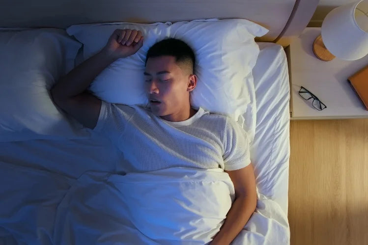A man sleeping while wearing a mouth guard