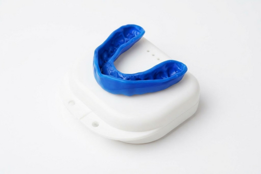 Blue sports mouth guard resting on a white storage case