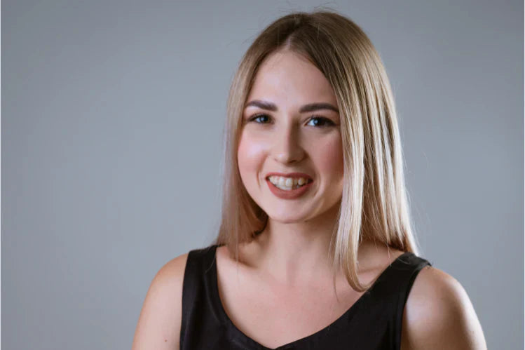  Image of a girl smiling with crooked teeth 