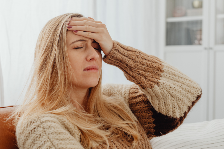 A girl waking up with a morning headache.