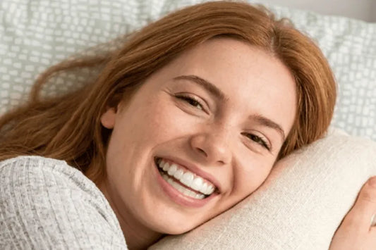 A woman wearing aligners to bed.