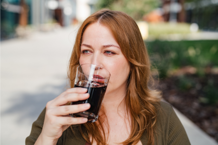 A woman drinking soda.