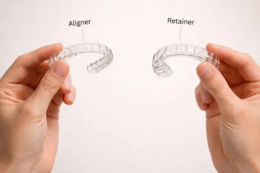 Two hands holding a clear aligner and a thicker retainer
