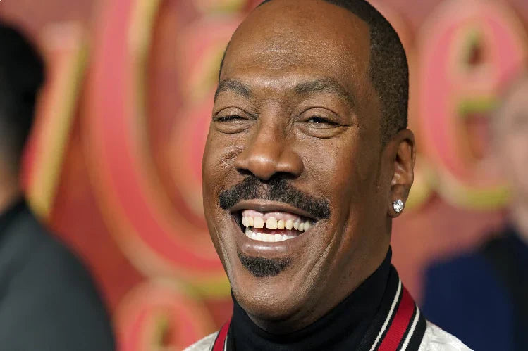 Eddie Murphy, a famous American actor, smiles with a visible gap between his front teeth