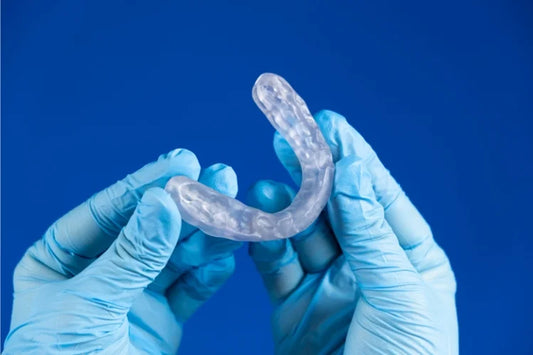 An image of hands holding a mouthguard